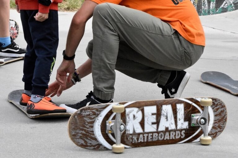 Instruktor pomaga młodemu skaterowi